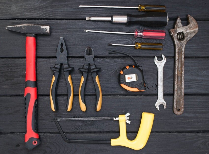 Garage door repair tools laying on dark wooden table