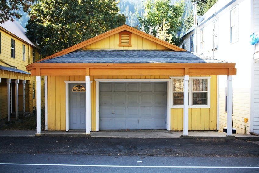 Yellow house with gray paneled one-car garage door