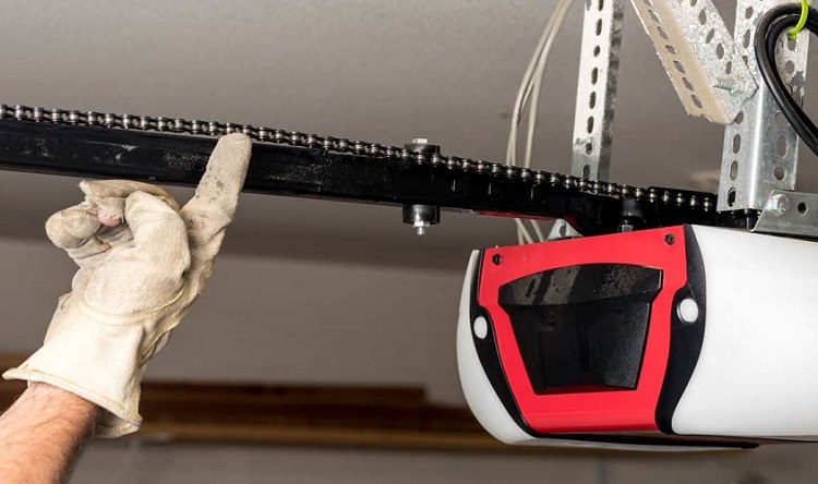 Garage door installer adjusting chain drive garage door opener model